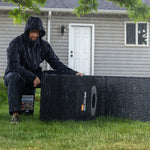 Holding up the Grid Doctor 200W waterproof Solar Panel in the rain